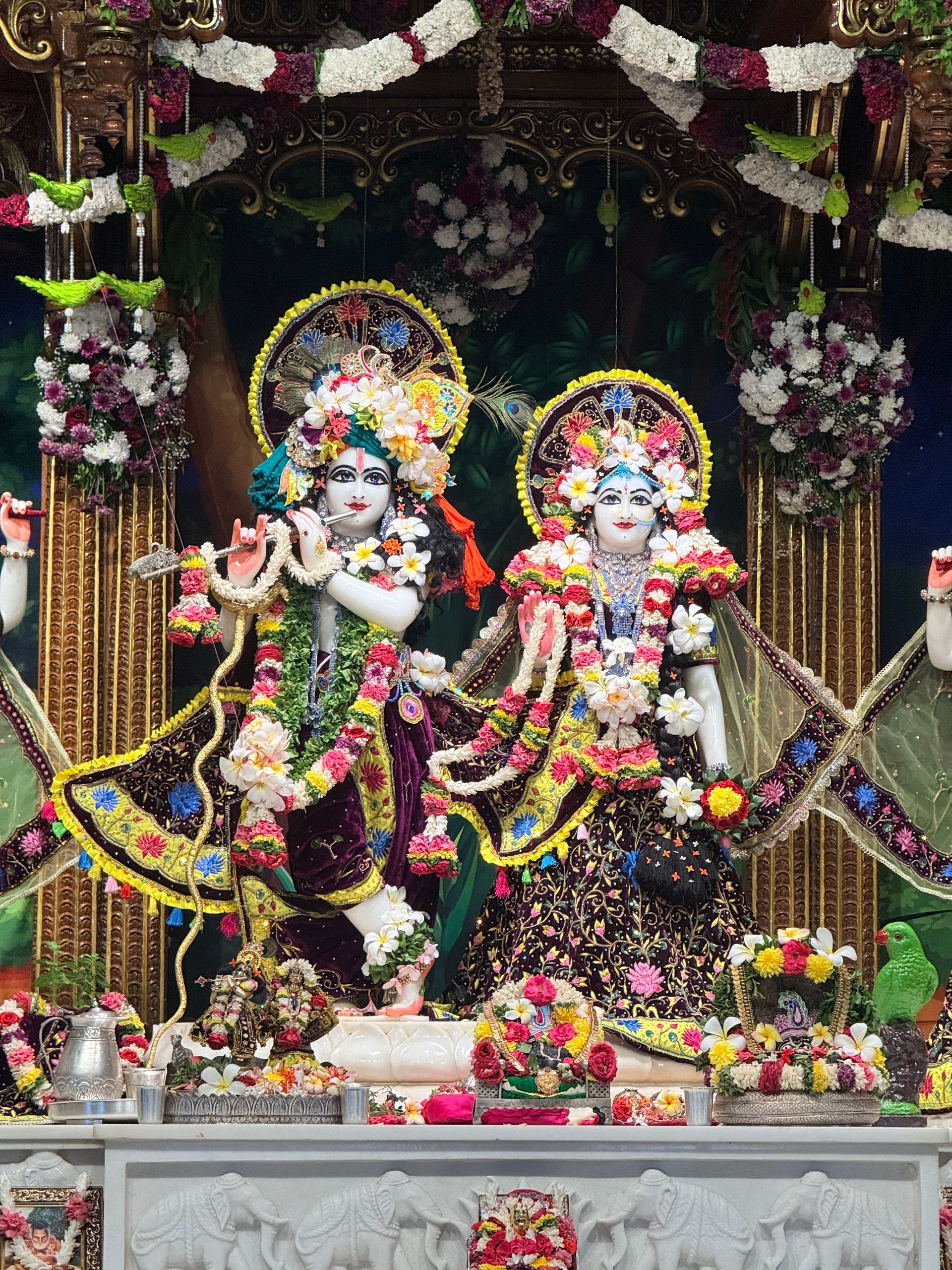 Vibrant statues of deities adorned with flowers and ornaments, capturing rich Indian culture.