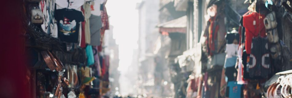 Vibrant and chaotic street scene in Nepal bustling with people and market stalls.
